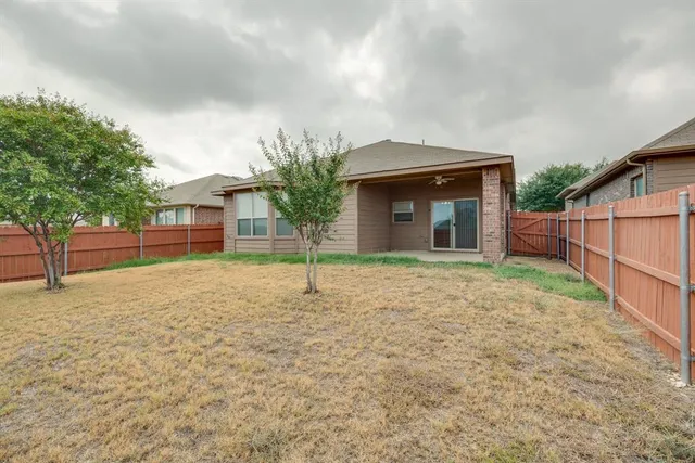 a house that has a tree in front of it
