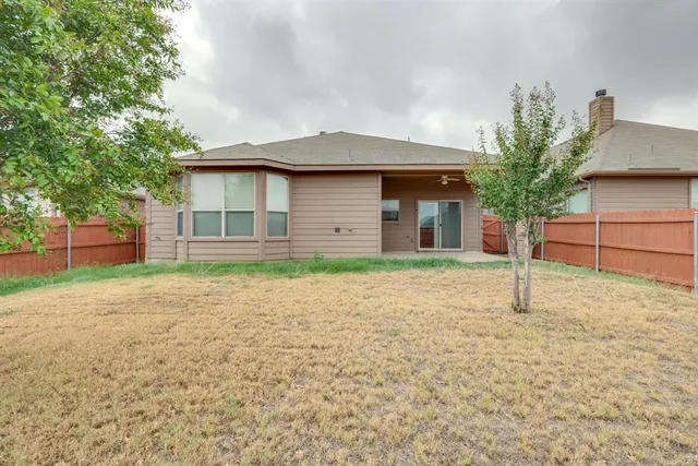 a house with a tree in the background