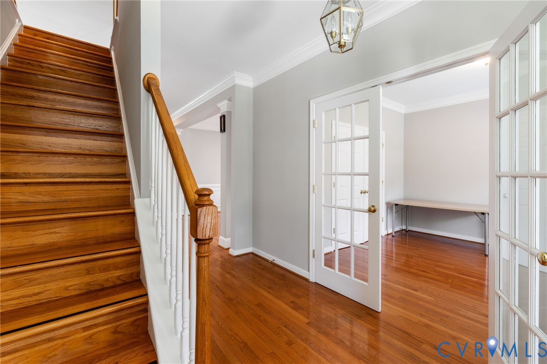 14225 Camack Trail Midlothian, VA 23114 - Photo 3 of 27 a view of a hallway with wooden floor and staircase
