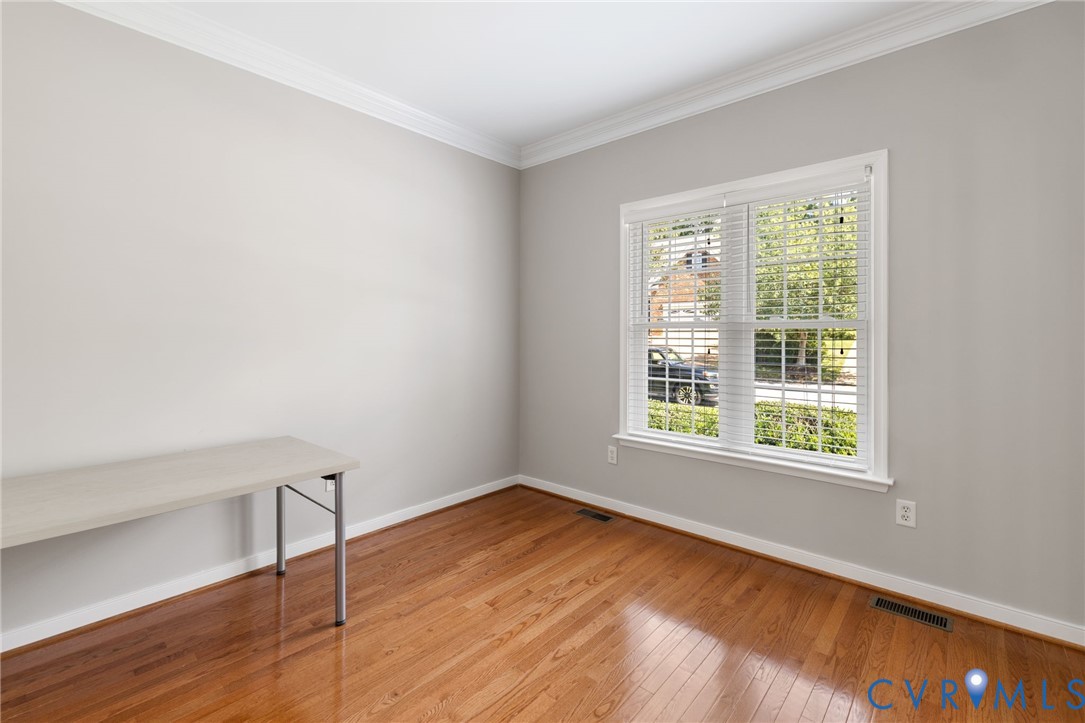 14225 Camack Trail Midlothian, VA 23114 - Photo 4 of 27 a view of an empty room with wooden floor and a window