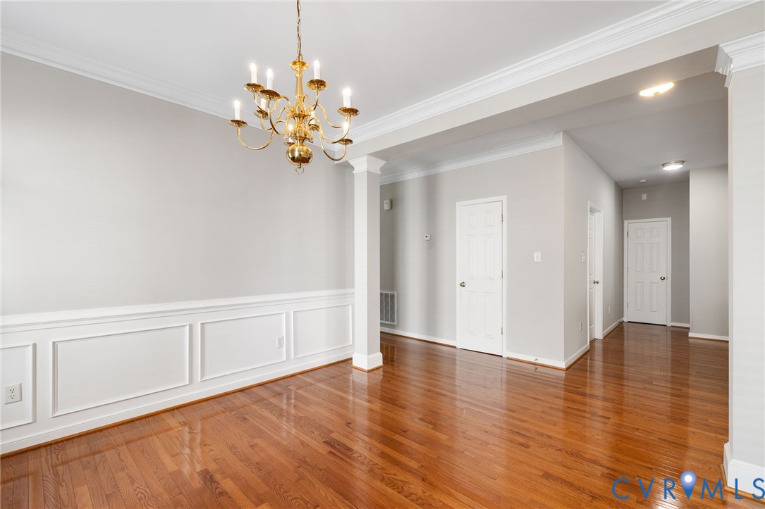 14225 Camack Trail Midlothian, VA 23114 - Photo 6 of 27 a view of an empty room with chandelier fan and wooden floor