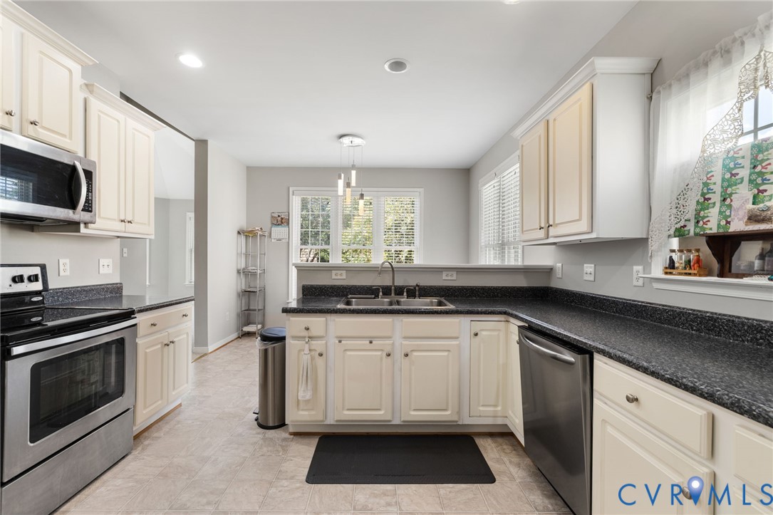 14225 Camack Trail Midlothian, VA 23114 - Photo 7 of 27 a kitchen with stainless steel appliances granite countertop a stove a sink and a microwave