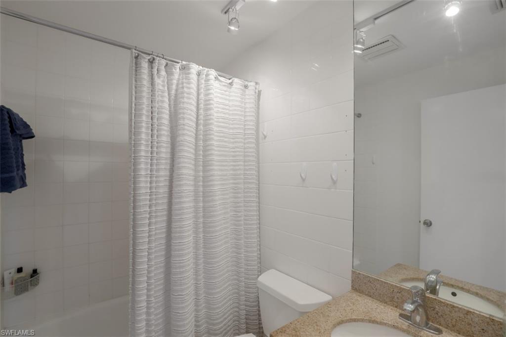 6640 Trail Boulevard Naples, FL 34108 - Photo 17 of 25 a bathroom with a granite countertop sink and a toilet