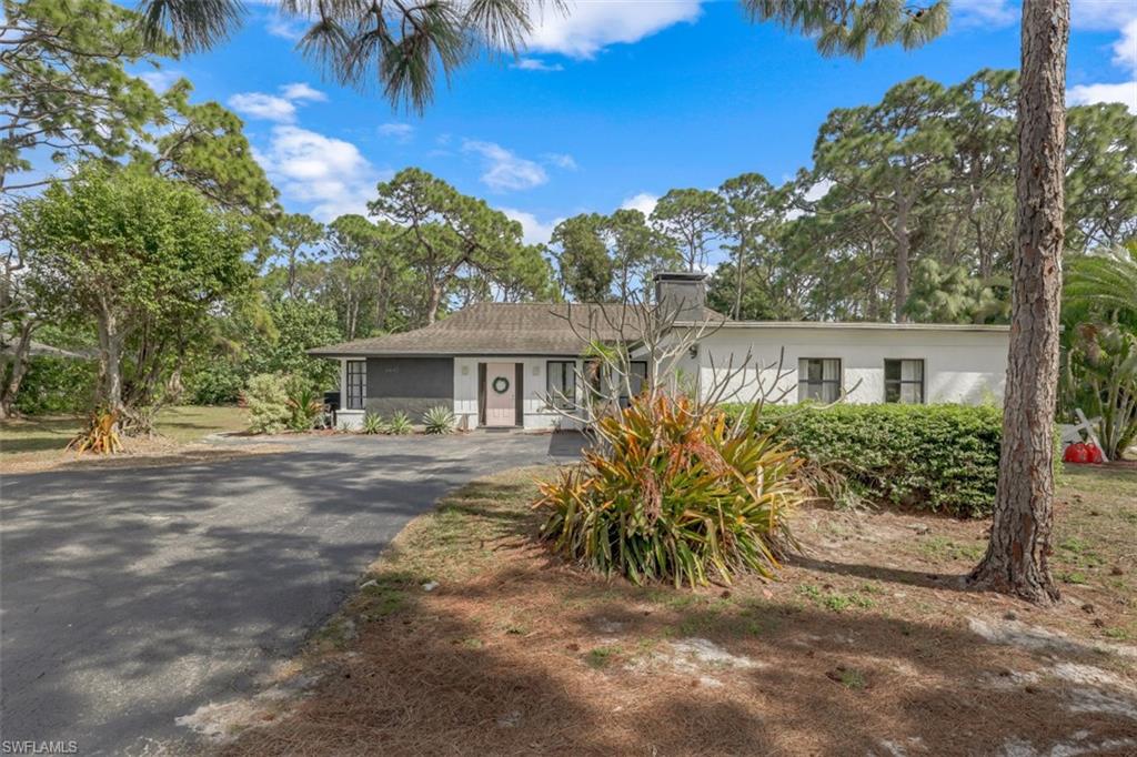 6640 Trail Boulevard Naples, FL 34108 - Photo 20 of 25 front view of a house with a yard