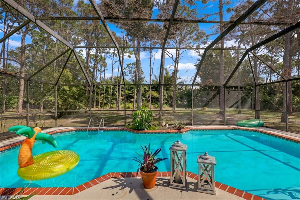 6640 Trail Boulevard Naples, FL 34108 - Photo 21 of 25 a view of a swimming pool with a patio