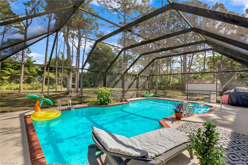 6640 Trail Boulevard Naples, FL 34108 - Photo 22 of 25 a view of a swimming pool with a patio