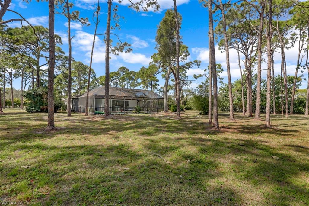 6640 Trail Boulevard Naples, FL 34108 - Photo 25 of 25 a front view of a house with a yard