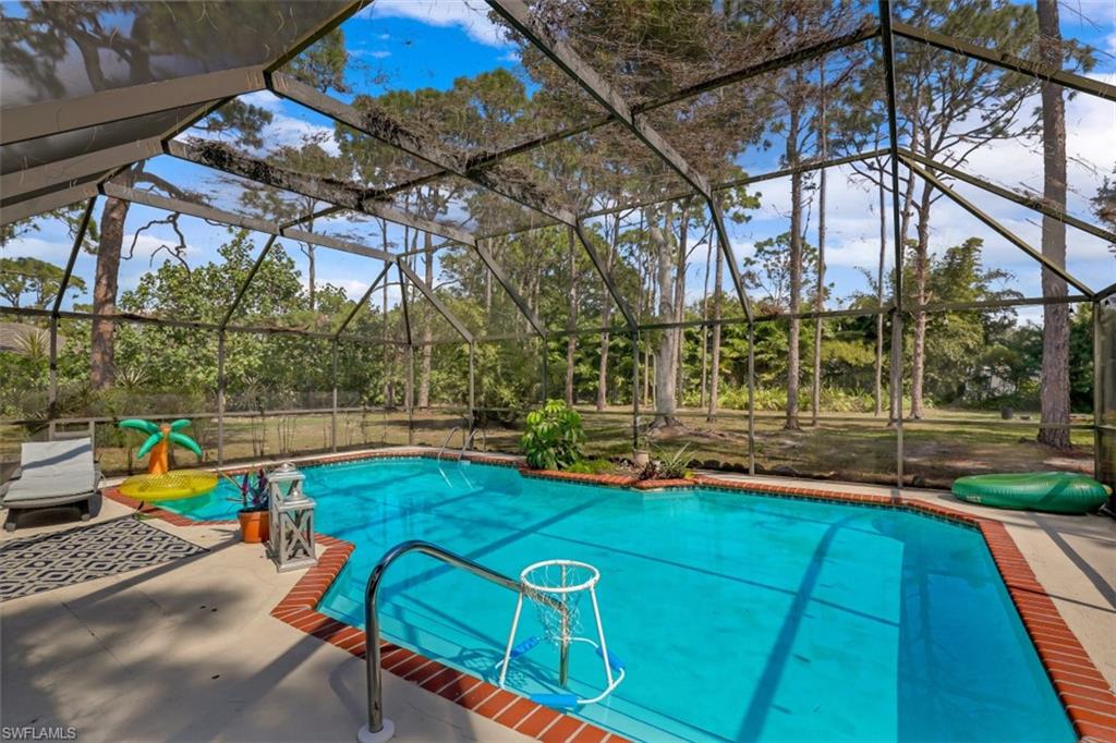 6640 Trail Boulevard Naples, FL 34108 - Photo 3 of 25 a view of yard with swimming pool and sitting area