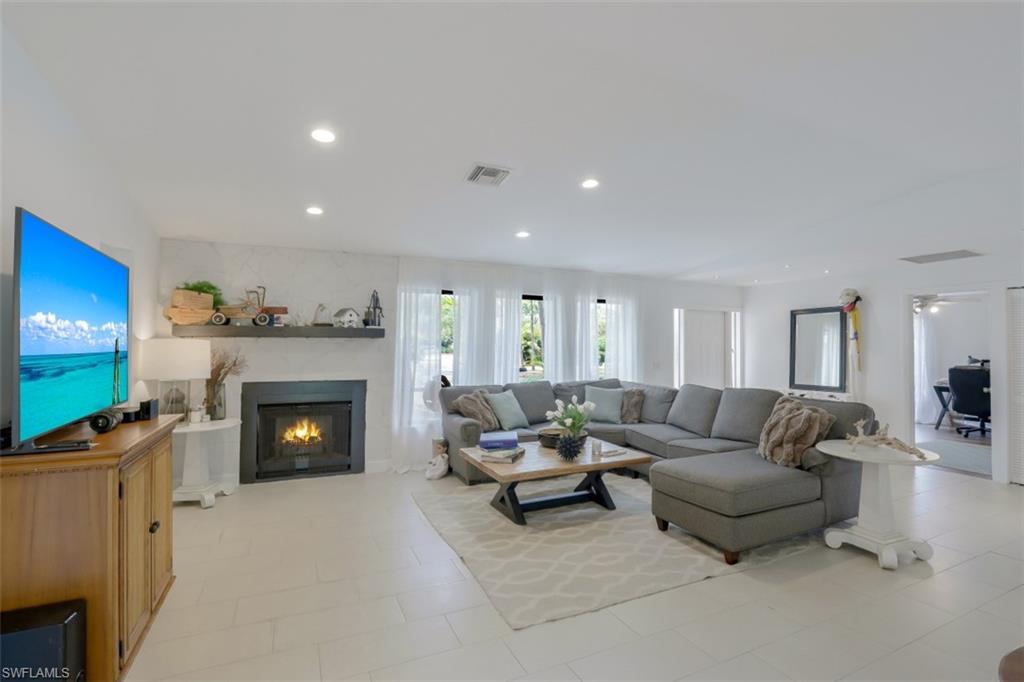 6640 Trail Boulevard Naples, FL 34108 - Photo 5 of 25 a living room with furniture and a fireplace