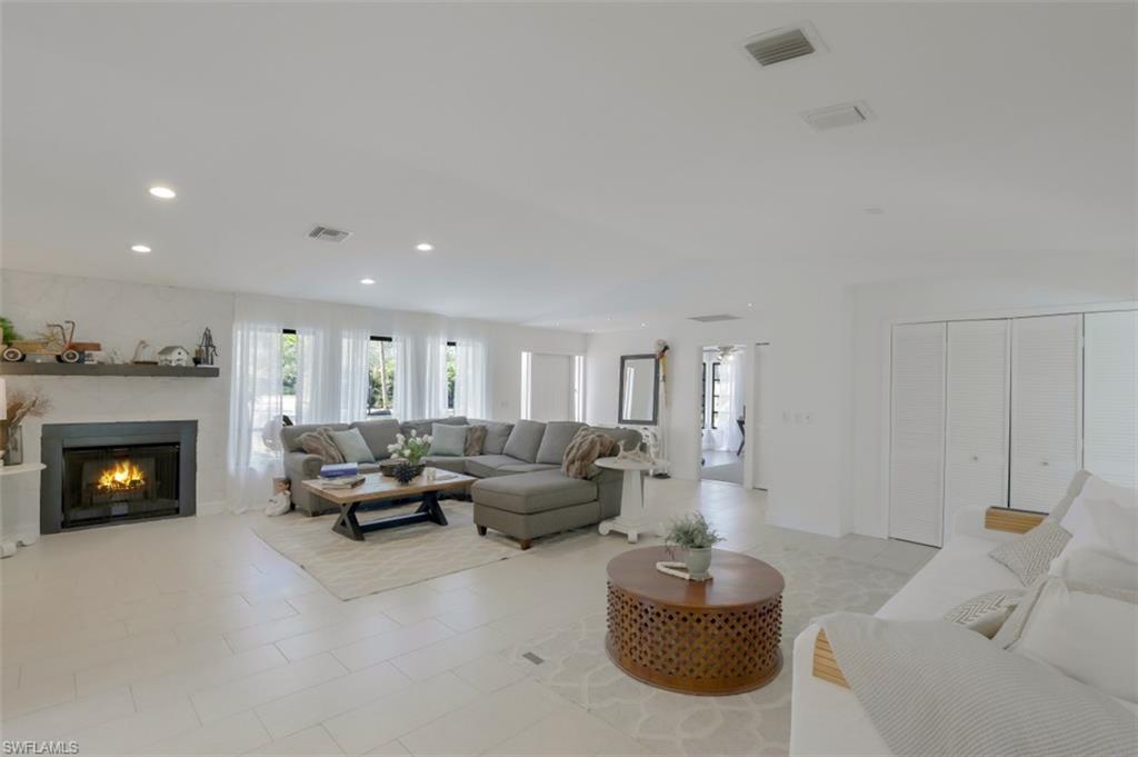 6640 Trail Boulevard Naples, FL 34108 - Photo 6 of 25 a living room with furniture and a fireplace