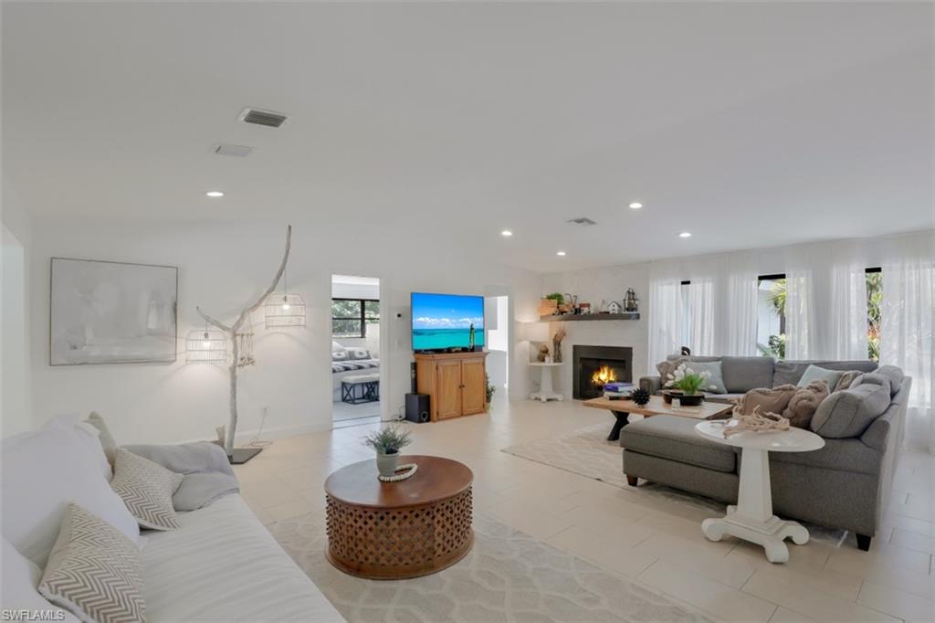 6640 Trail Boulevard Naples, FL 34108 - Photo 7 of 25 a living room with furniture and a wooden floor