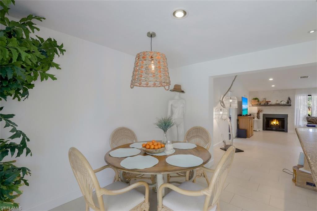 6640 Trail Boulevard Naples, FL 34108 - Photo 9 of 25 a dining room with furniture and a floor to ceiling window