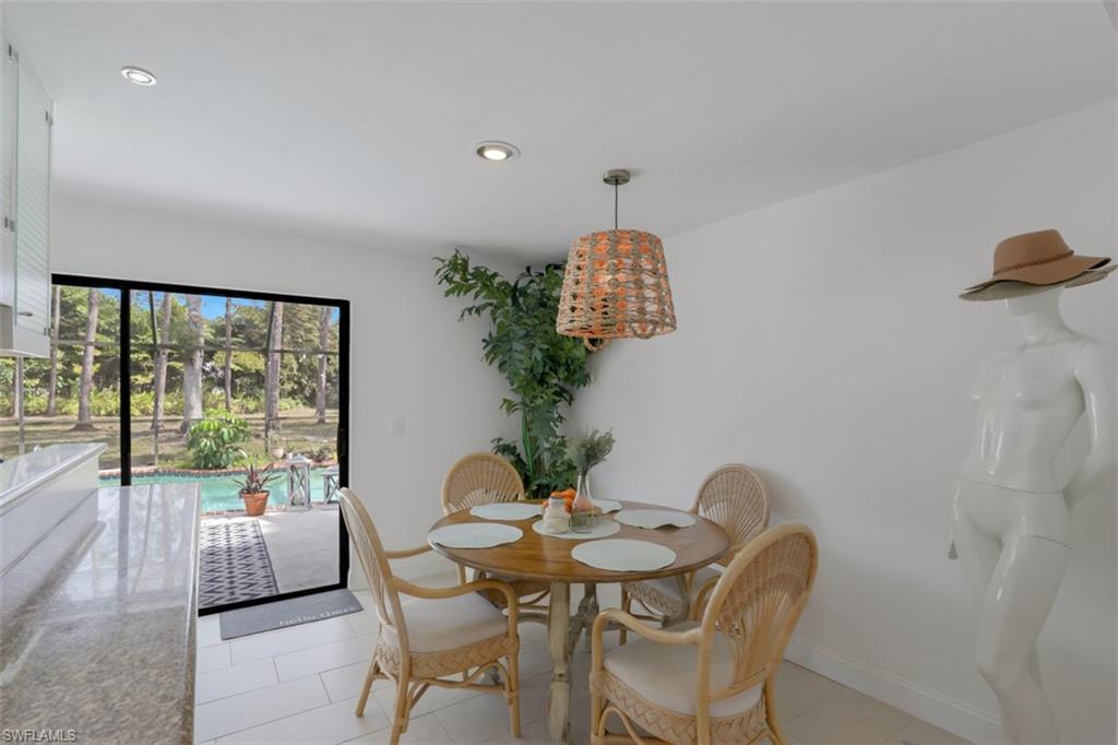 6640 Trail Boulevard Naples, FL 34108 - Photo 10 of 25 a dining room with furniture and wooden floor