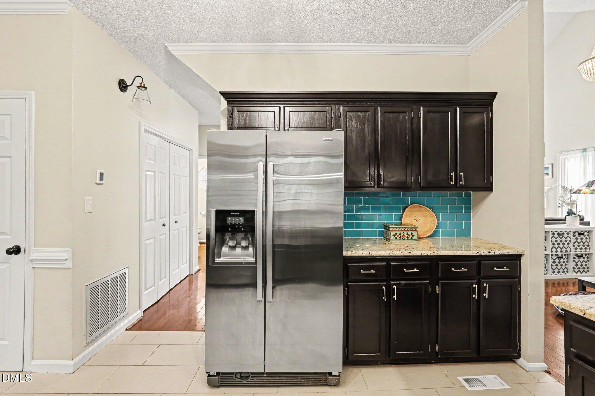 5468 Ingate Way Raleigh, NC 27613 - Photo 7 of 24 a kitchen with stainless steel appliances granite countertop a refrigerator and a sink