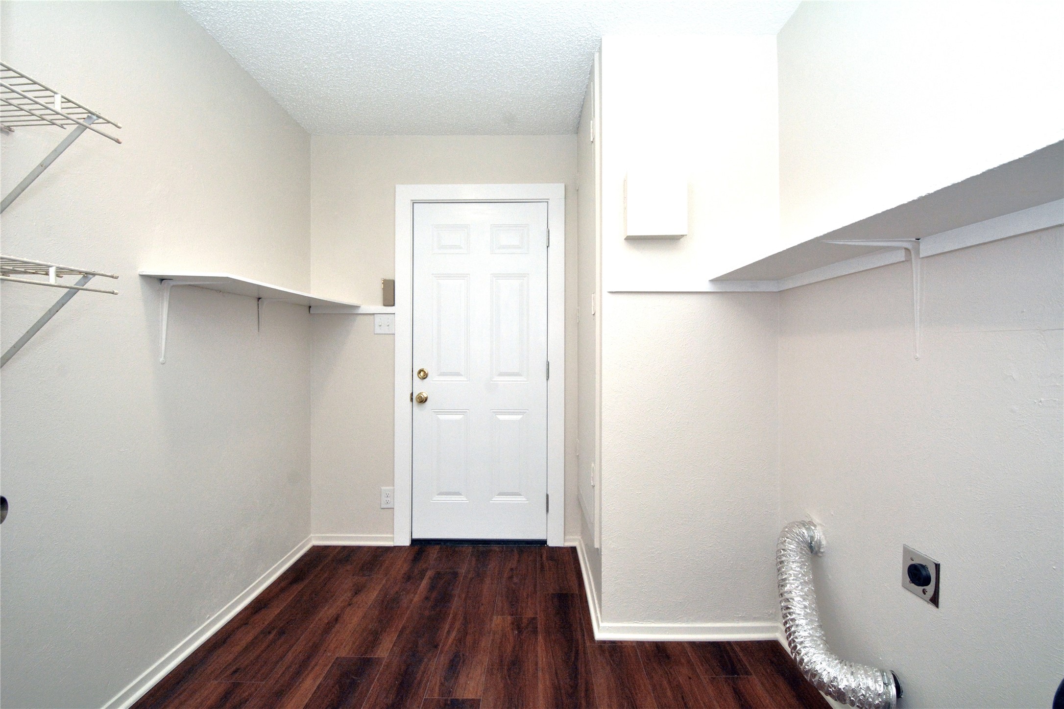 11314 Walnut Ridge Drive, Unit B Austin, TX 78753 - Photo 11 of 19 Functional laundry room featuring sturdy shelving and durable wood-look flooring.