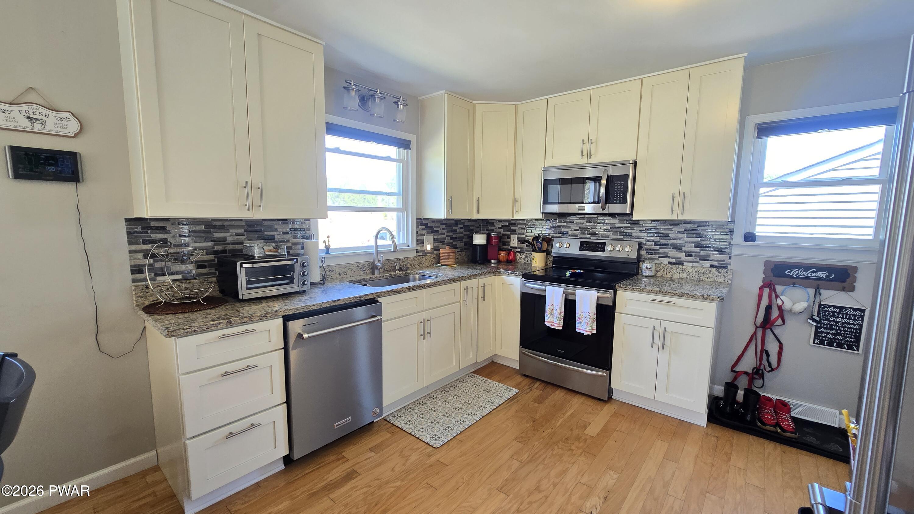 430 Griffith Road Tyler Hill, PA 18469 - Photo 5 of 31 a kitchen with stainless steel appliances a stove sink microwave and cabinets