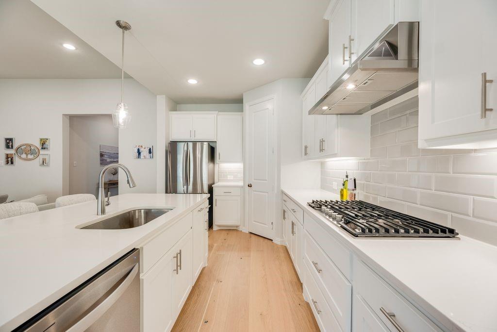 227 Buffalo Boulevard Rhome, TX 76078 - Photo 16 of 39 a kitchen with kitchen island a counter top space a sink stainless steel appliances and cabinets