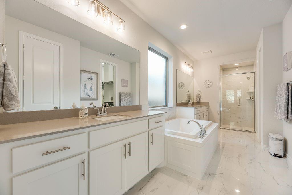227 Buffalo Boulevard Rhome, TX 76078 - Photo 19 of 39 a bathroom with a sink a toilet a tub and a large mirror