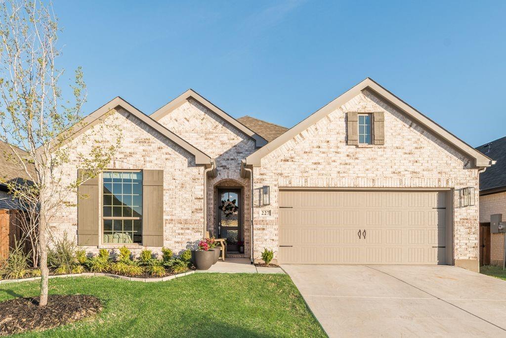 227 Buffalo Boulevard Rhome, TX 76078 - Photo 2 of 39 a front view of a house with garden