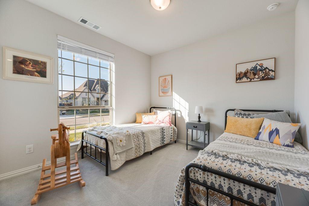 227 Buffalo Boulevard Rhome, TX 76078 - Photo 24 of 39 a bedroom with two beds and window