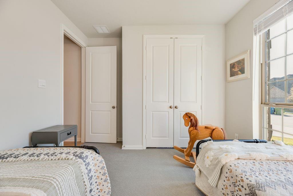 227 Buffalo Boulevard Rhome, TX 76078 - Photo 25 of 39 a bedroom with bed chair and window