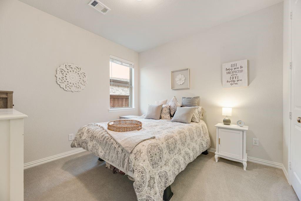 227 Buffalo Boulevard Rhome, TX 76078 - Photo 28 of 39 a bedroom with a bed and a window