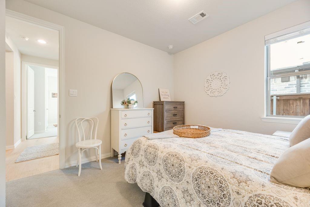 227 Buffalo Boulevard Rhome, TX 76078 - Photo 30 of 39 a bedroom with a bed and a chair