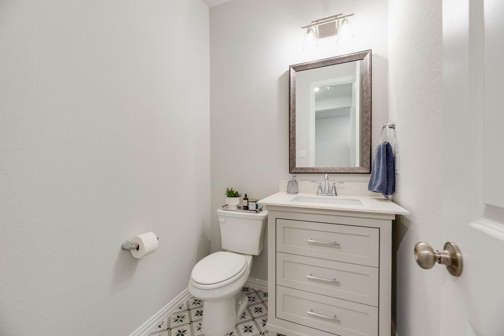 227 Buffalo Boulevard Rhome, TX 76078 - Photo 32 of 39 a bathroom with a granite countertop toilet sink and mirror