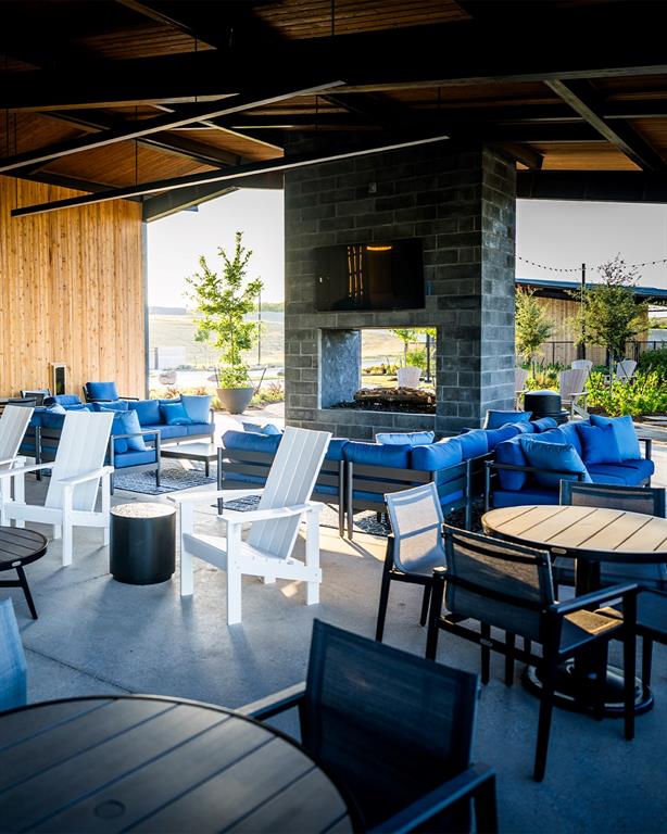 227 Buffalo Boulevard Rhome, TX 76078 - Photo 36 of 39 a living room with furniture and a flat screen tv