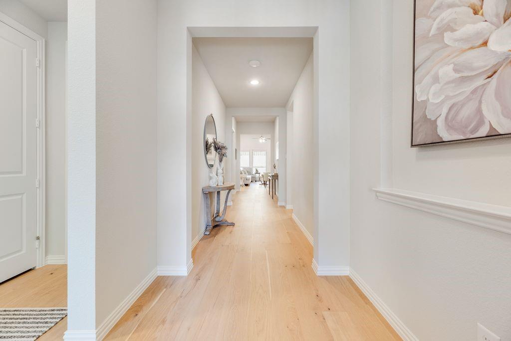 227 Buffalo Boulevard Rhome, TX 76078 - Photo 4 of 39 a view of a hallway with a wooden floor