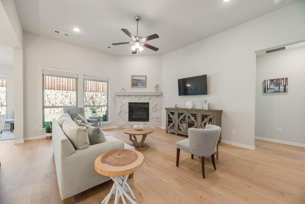227 Buffalo Boulevard Rhome, TX 76078 - Photo 5 of 39 a living room with furniture a fireplace and a flat screen tv