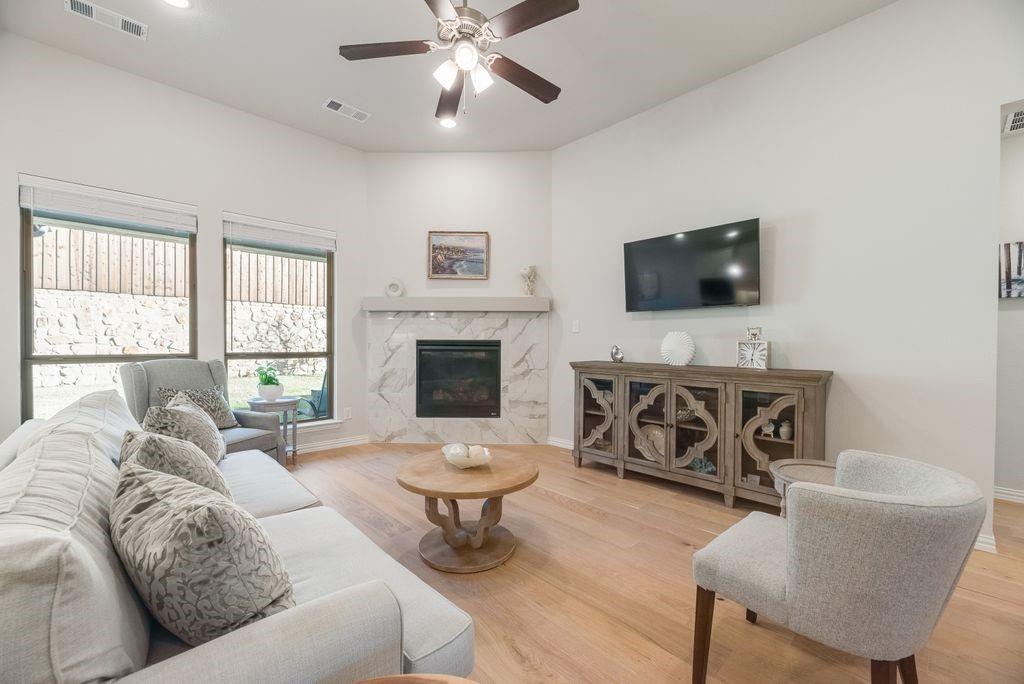 227 Buffalo Boulevard Rhome, TX 76078 - Photo 6 of 39 a living room with furniture a fireplace and a flat screen tv