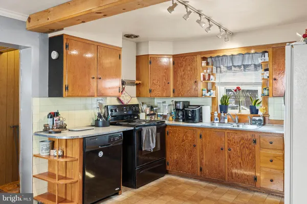 a kitchen with stainless steel appliances granite countertop a stove and a refrigerator
