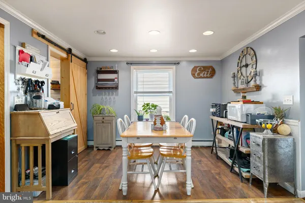 a dining room with furniture and wooden floor