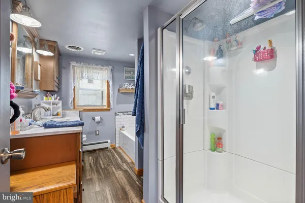 a en suite bathroom with a shower sink and mirror