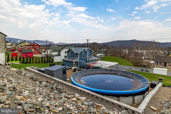 an aerial view of a house with swimming pool and mountain view