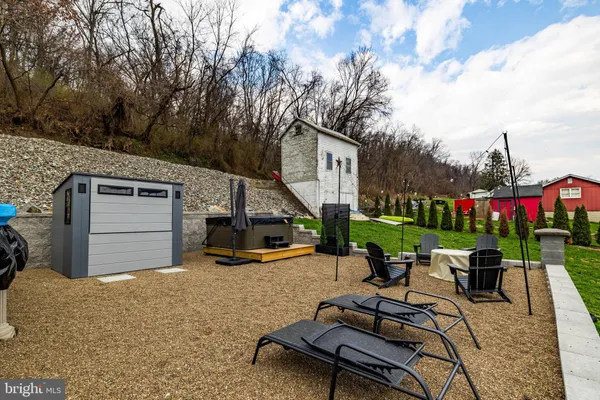 a view of a backyard with sitting area