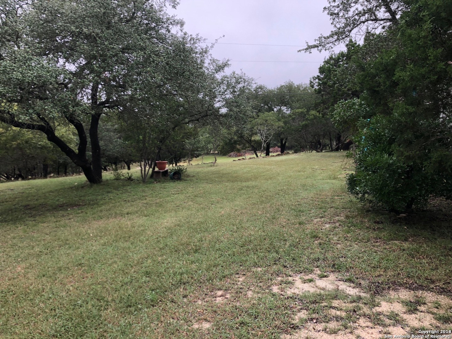 403 Los Indios Road Boerne, TX 78006 - Photo 3 of 21 a view of outdoor space with green field and trees