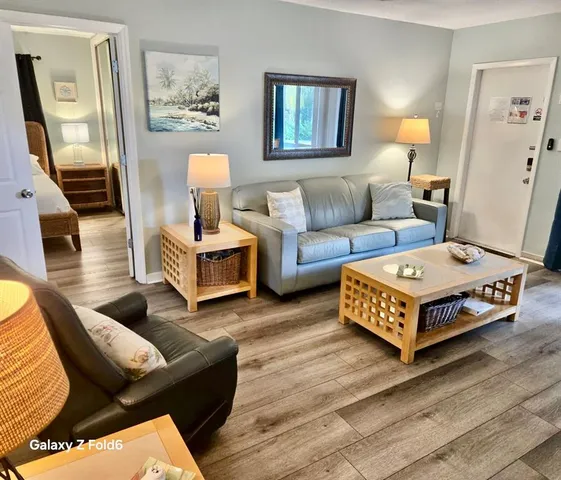 a living room with furniture and wooden floor