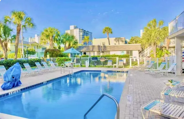 a swimming pool with outdoor seating and yard
