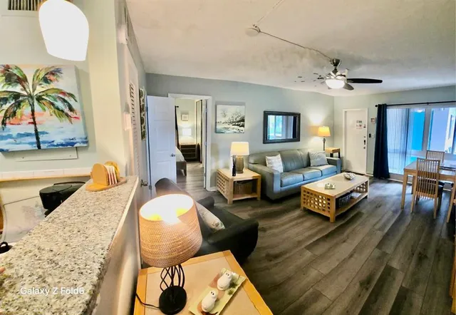 a living room with furniture potted plant and a fireplace