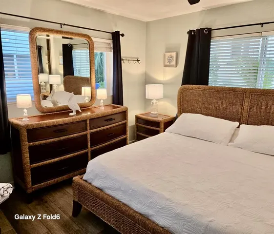 a bedroom with a large bed and a window