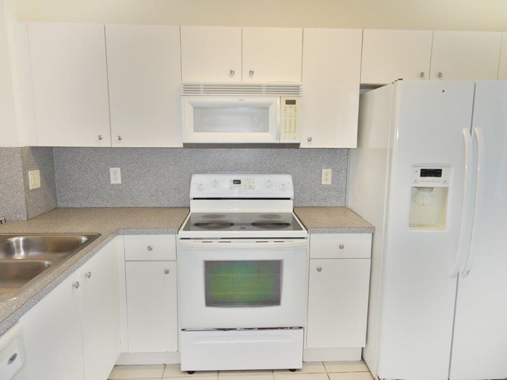 5927 Riverside Avenue Tamarac, FL 33321 - Photo 2 of 15 a kitchen with cabinets appliances and a sink
