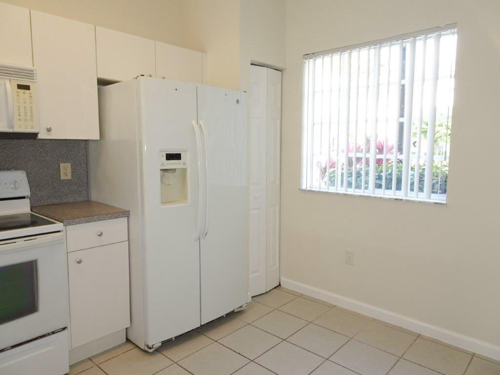 5927 Riverside Avenue Tamarac, FL 33321 - Photo 3 of 15 a view of a kitchen with white cabinets and window
