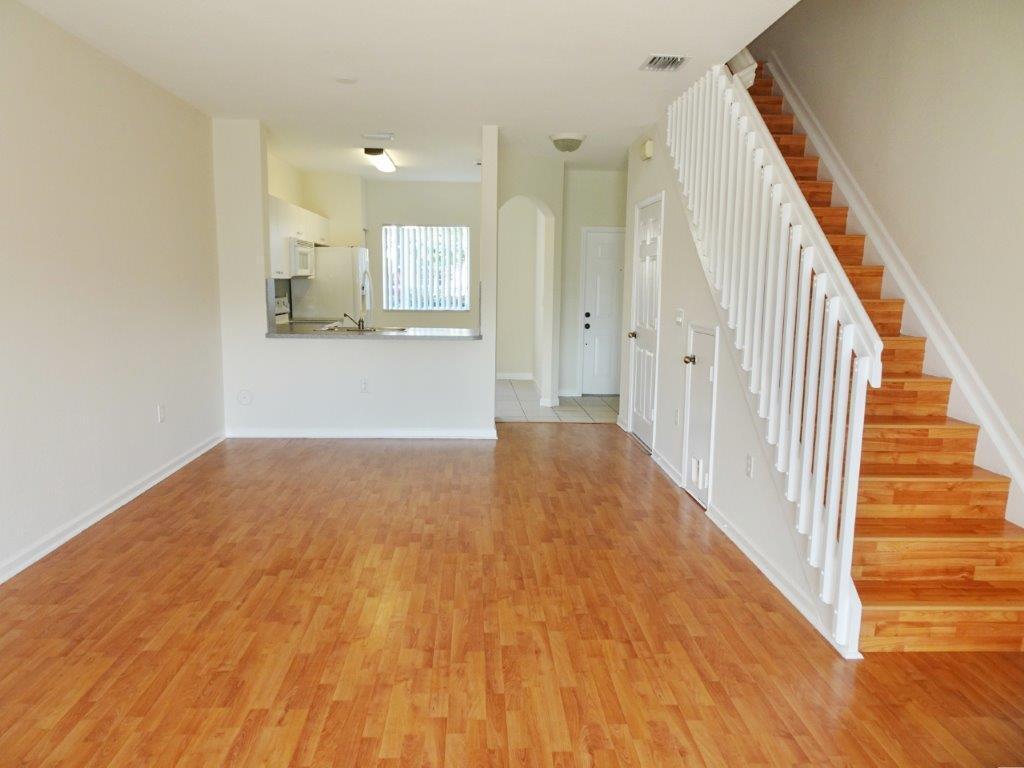5927 Riverside Avenue Tamarac, FL 33321 - Photo 4 of 15 a view of a hallway with wooden floor and staircase