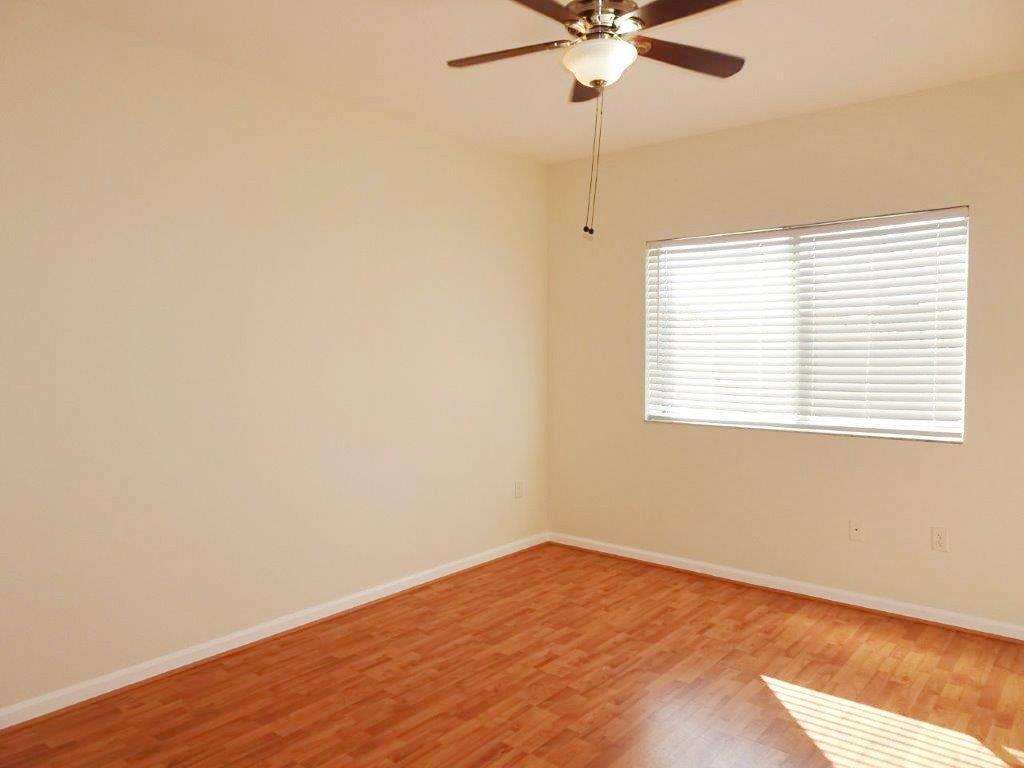 5927 Riverside Avenue Tamarac, FL 33321 - Photo 6 of 15 an empty room with a window and a fan