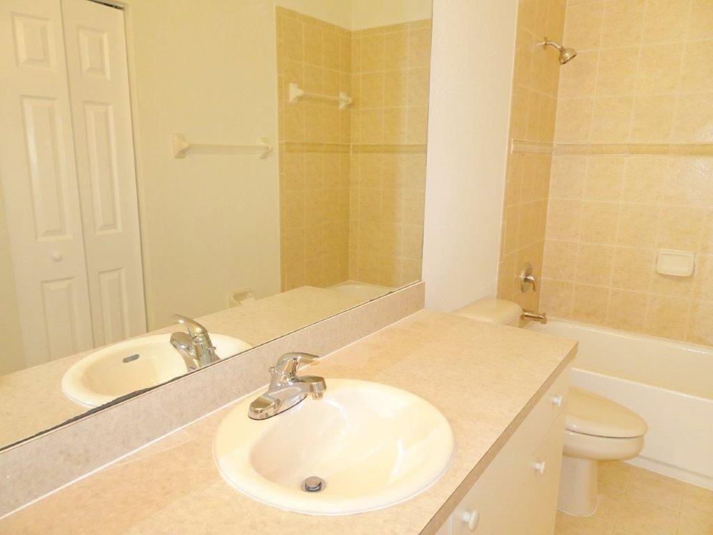 5927 Riverside Avenue Tamarac, FL 33321 - Photo 9 of 15 a bathroom with a sink and a mirror