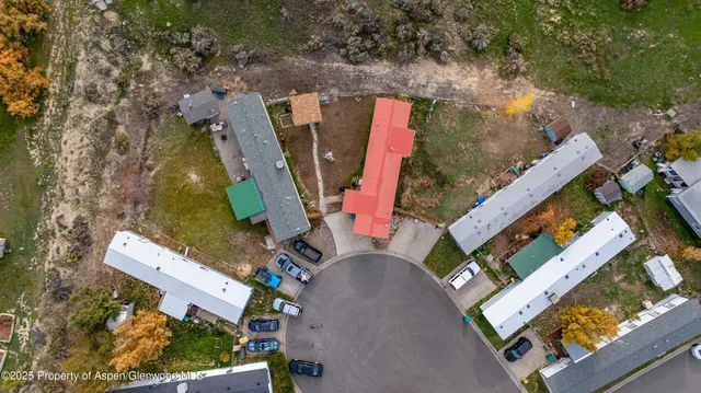 an aerial view of a house with a yard and garden