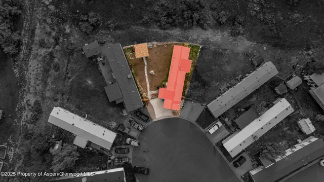 an aerial view of a house with a yard and garden