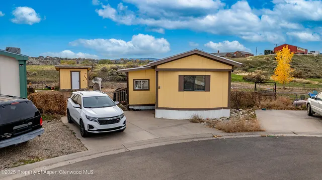 a view of a car park in front of house